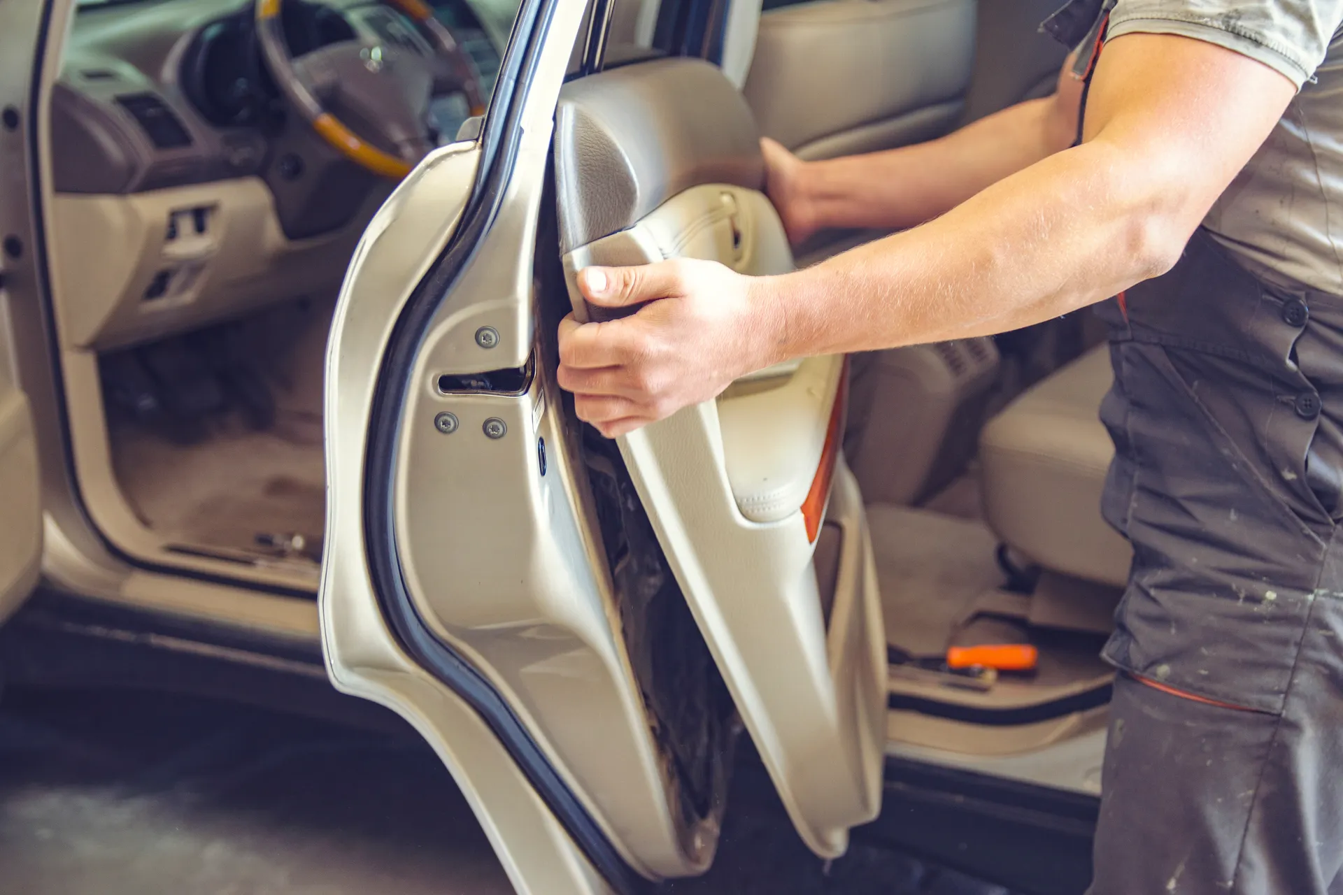 removing the car door panel to access the door lock actuator