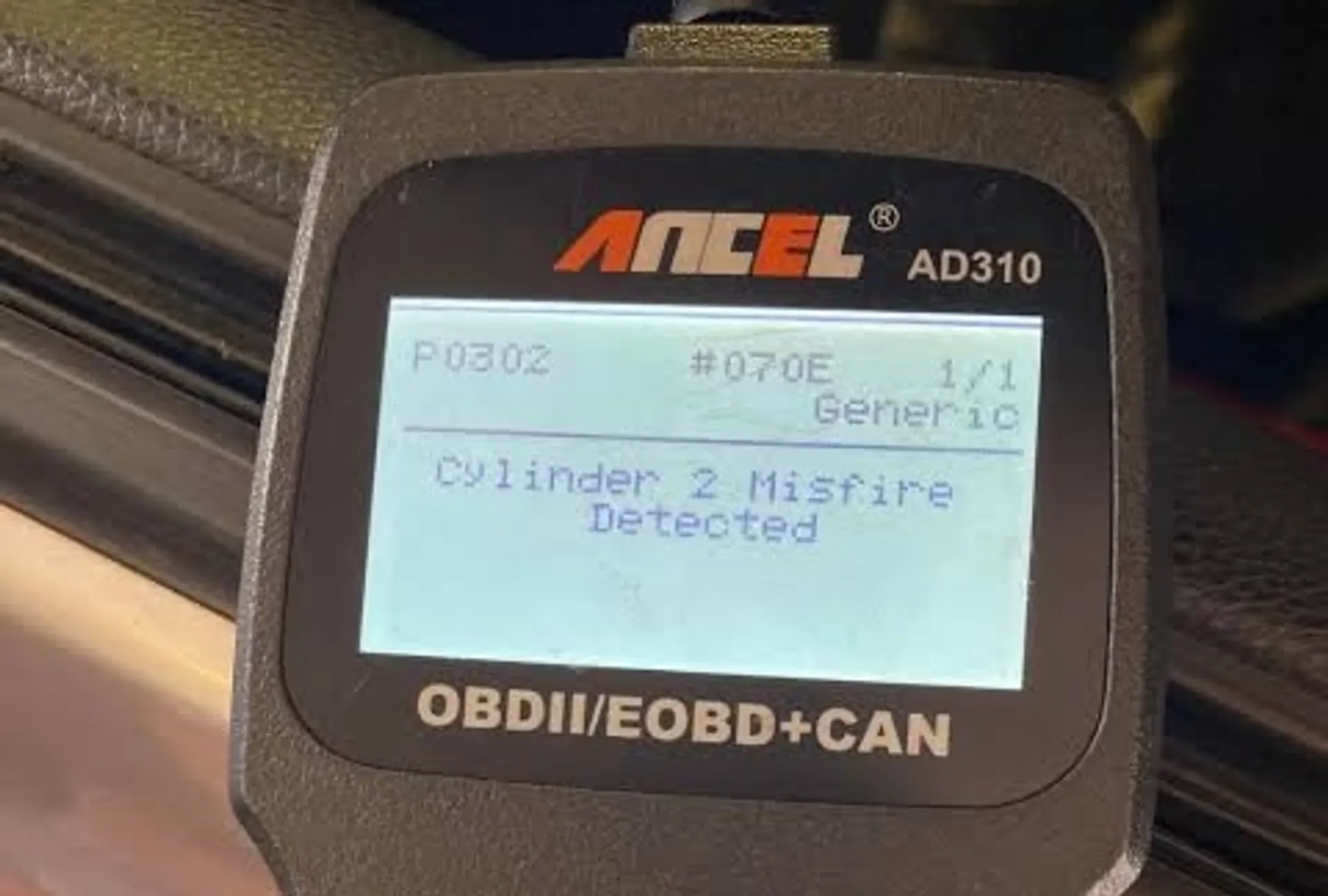 OBD2 scanner displaying P0302 cylinder 2 misfire detected