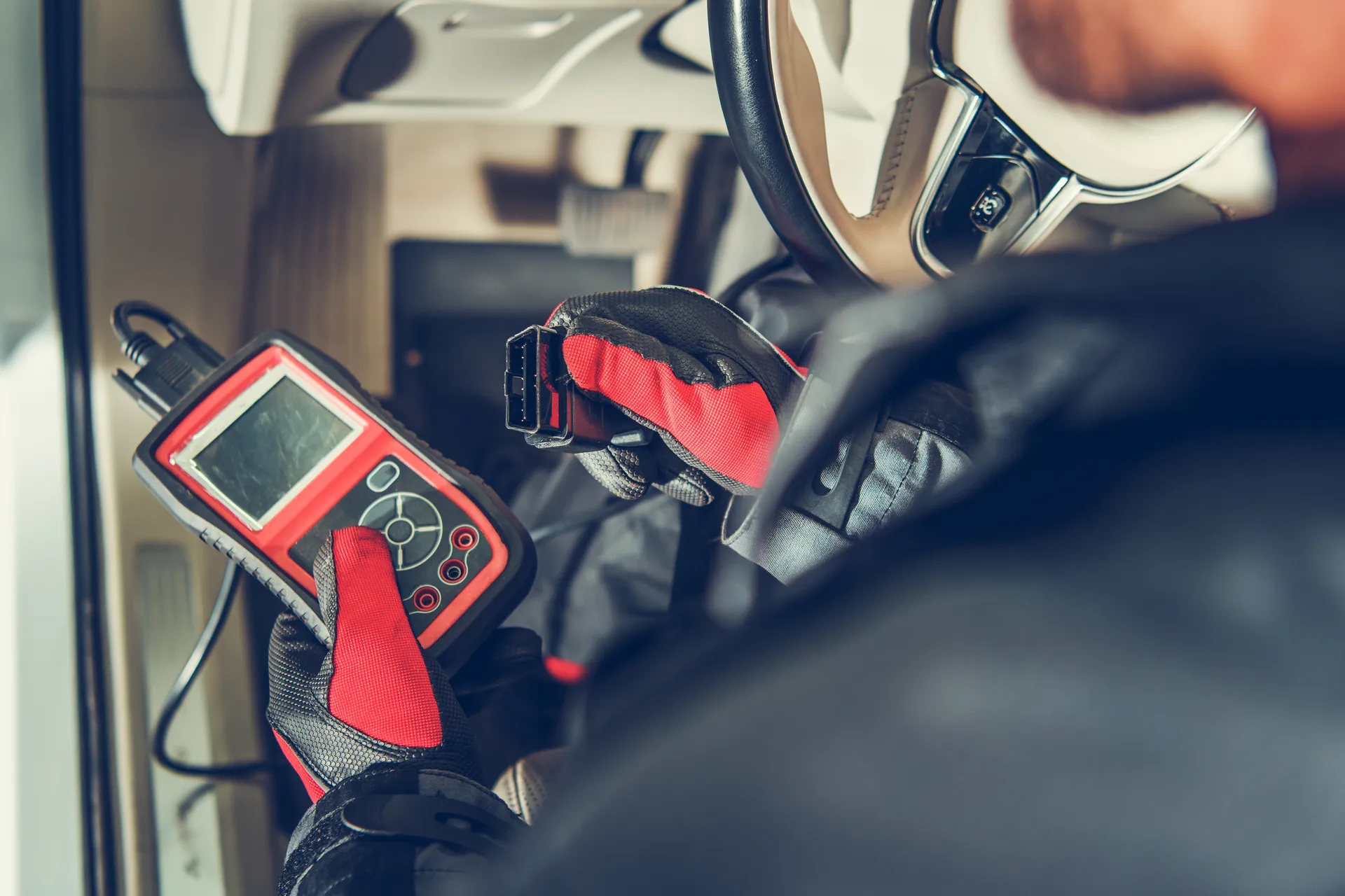 a mechanic uses OBD2 to check engine fault code
