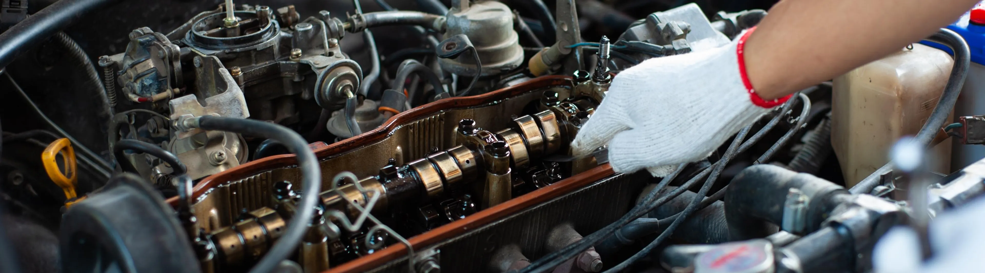a mechanic inspect the engine timing system