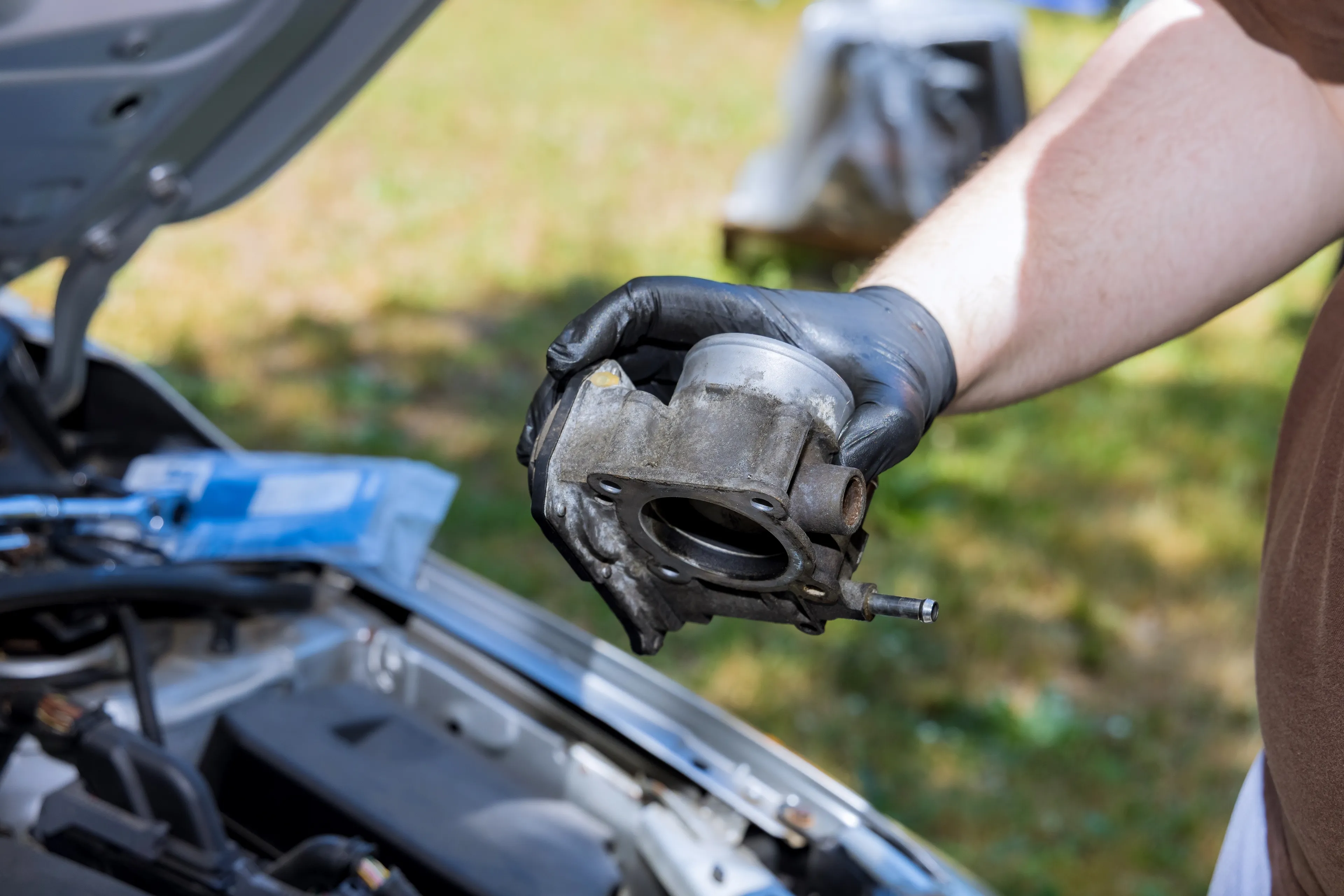 a man removes a throttle body